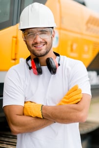 Worker at a construction site working with heavy machines