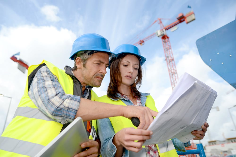 Construction manager and engineer working on building site