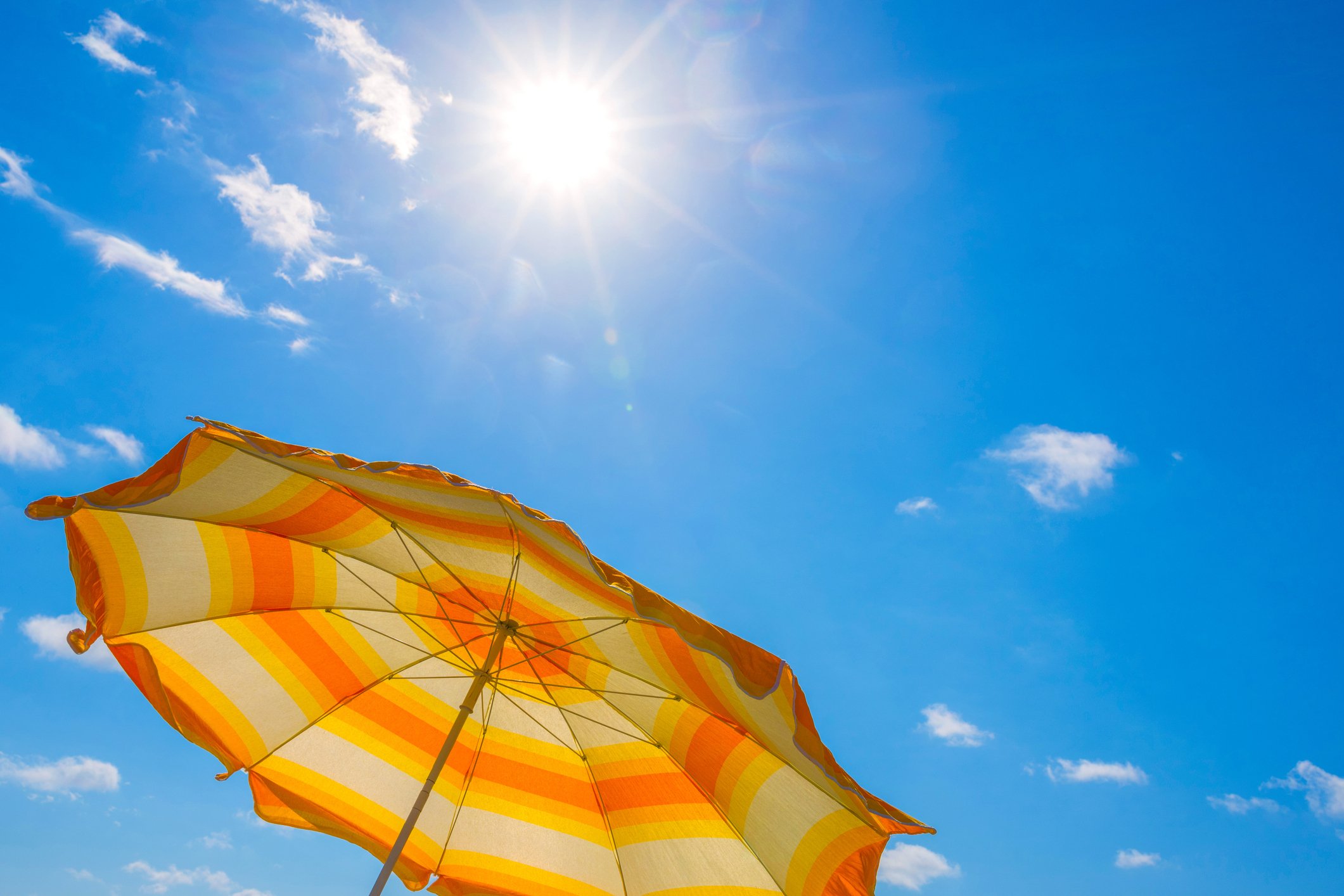 Beach umbrella on a summer day with the sun out